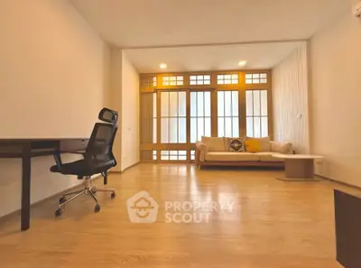 Spacious modern living room with wooden flooring and stylish furniture