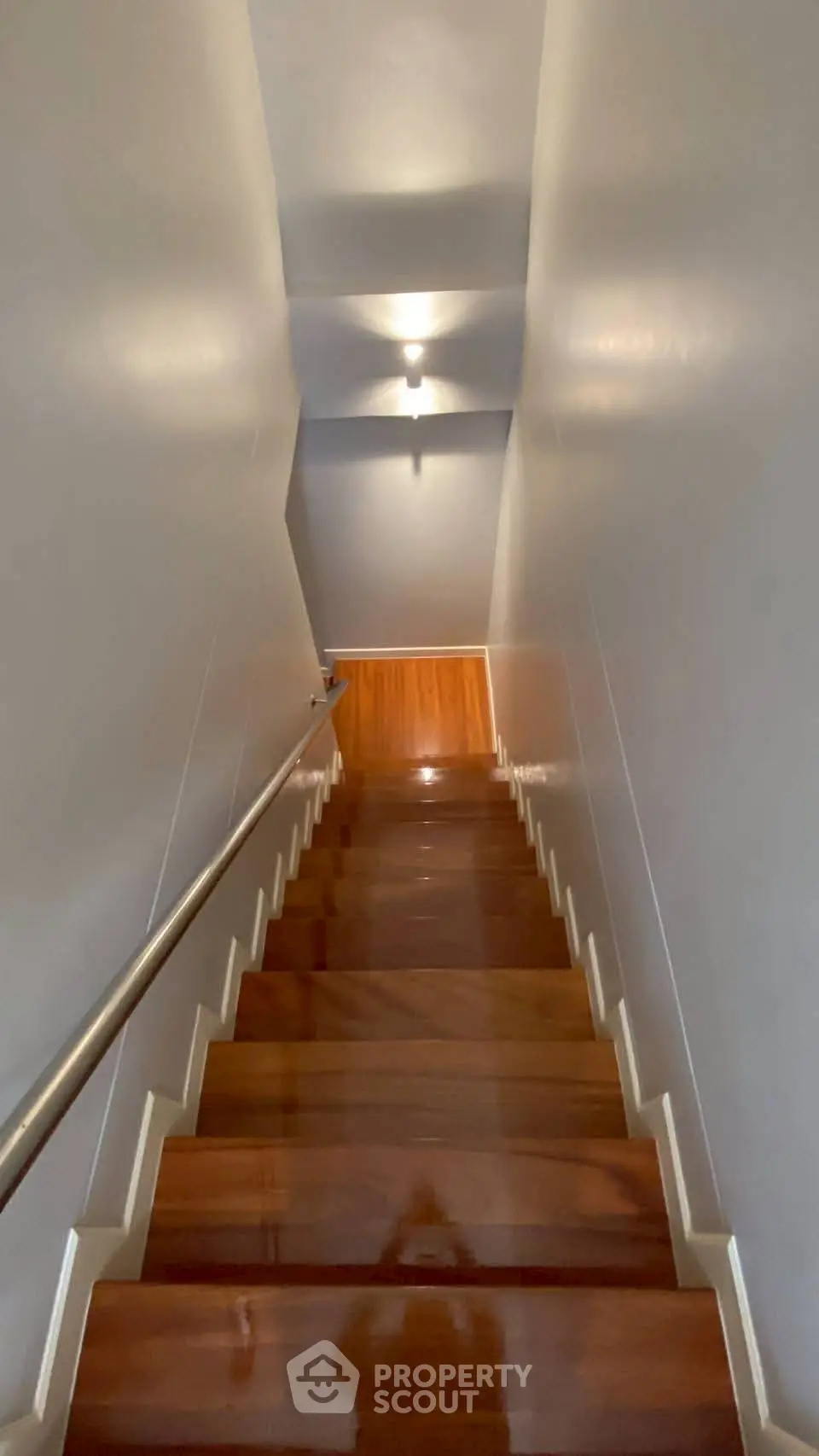 Elegant wooden staircase with sleek handrail in modern home interior