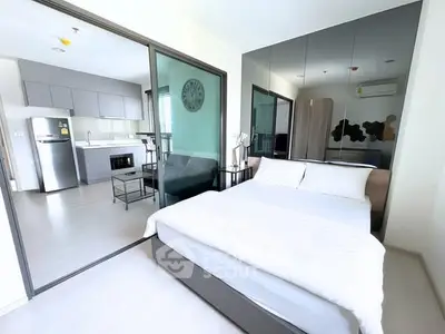 Modern studio apartment with open kitchen and cozy bedroom