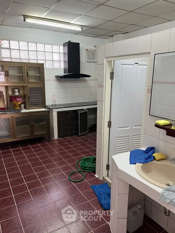 Spacious kitchen with tiled flooring and modern cabinetry
