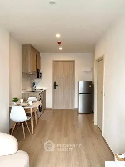 Modern apartment interior with compact kitchen and cozy dining area