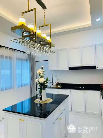 Luxurious modern kitchen with elegant lighting and sleek black countertops.