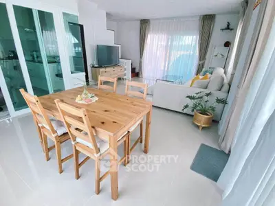 Bright and airy living room with modern dining area and cozy seating, perfect for family gatherings.