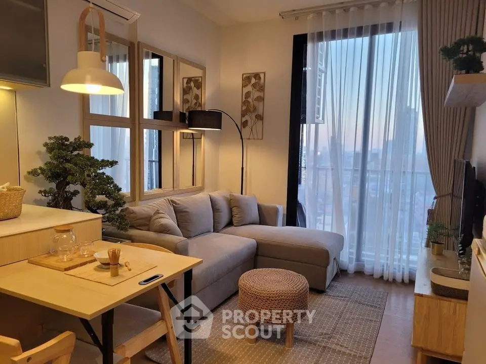 Cozy modern living room with city view, stylish decor, and natural light.