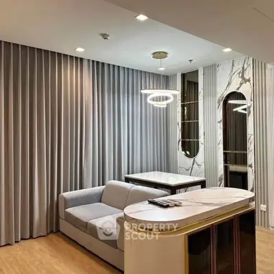 Modern living room with elegant marble accents and stylish lighting