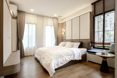 Spacious modern bedroom with elegant decor and natural light