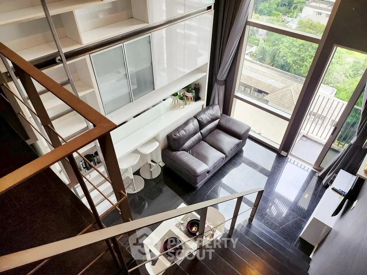Modern loft apartment with sleek design and large windows offering a stunning view.