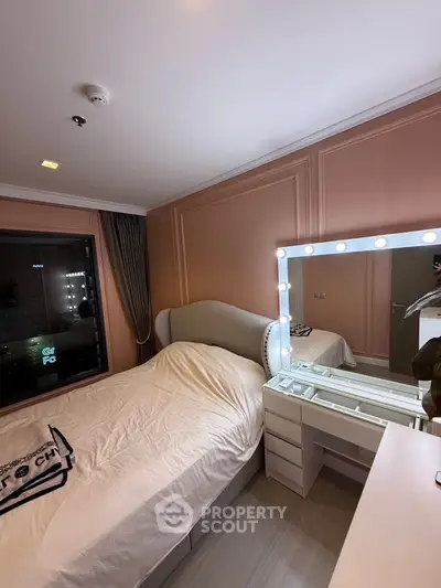 Cozy bedroom with elegant lighting and stylish vanity mirror, perfect for modern living.