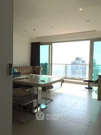 Spacious modern living room with large windows and city view, featuring elegant furniture and natural light.