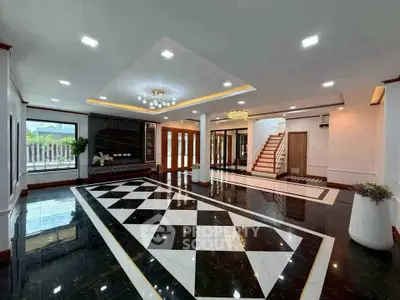 Luxurious modern living room with elegant black and white marble flooring and stylish lighting.