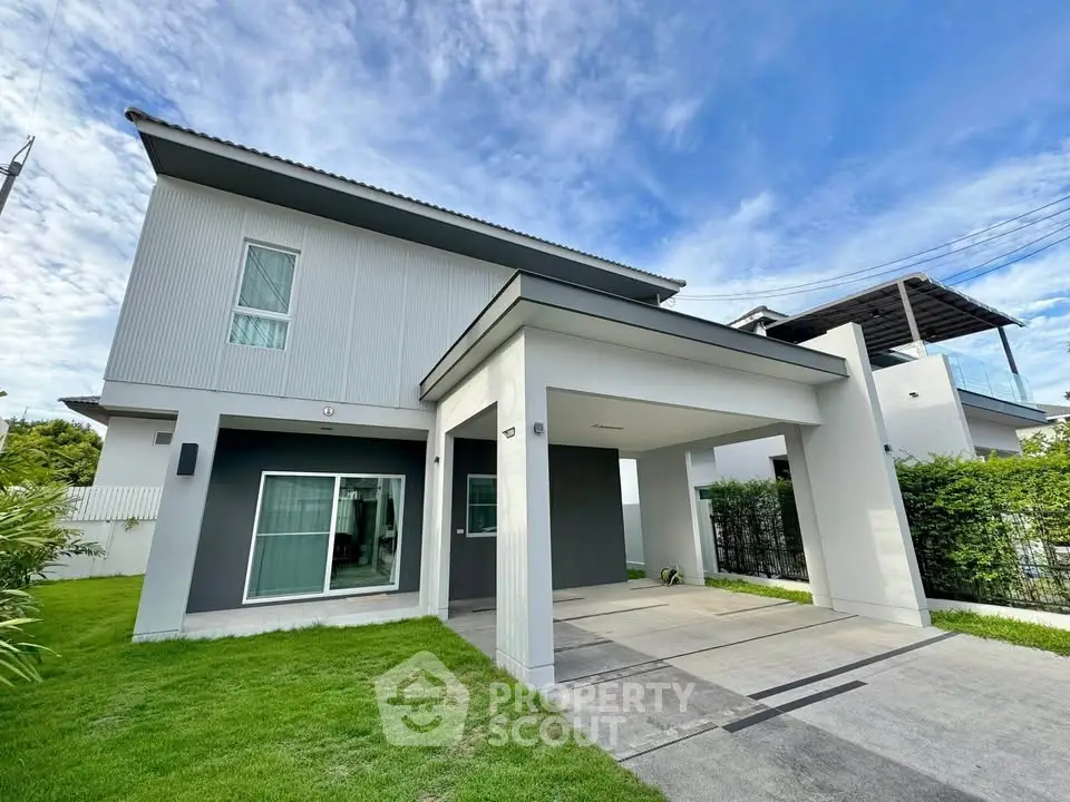 Modern two-story house with sleek design and spacious driveway in a serene neighborhood.