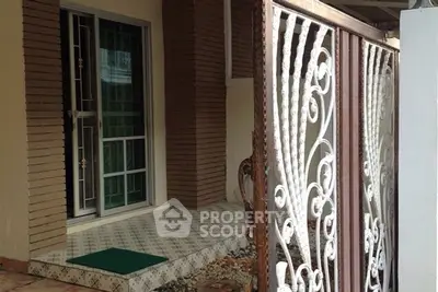 Charming entrance with ornate gate and tiled porch, perfect for welcoming guests.