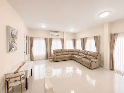 Spacious living room with elegant decor and ample natural light