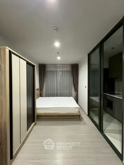 Modern bedroom with sleek design and large wardrobe in a stylish apartment.