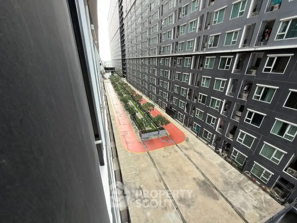 Modern apartment complex with courtyard view and multiple windows