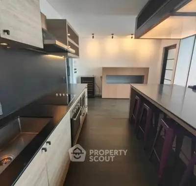 Modern kitchen with sleek black countertops and wooden cabinetry