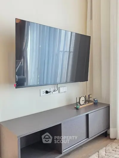 Modern living room with wall-mounted TV and stylish cabinet