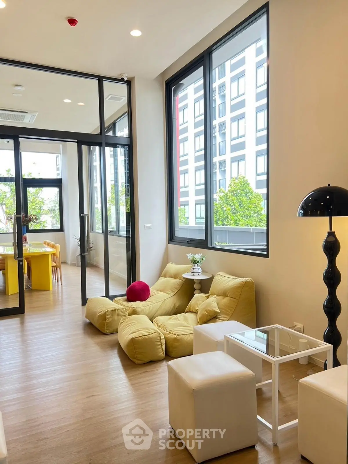 Modern living room with large windows and stylish furniture in a contemporary apartment.
