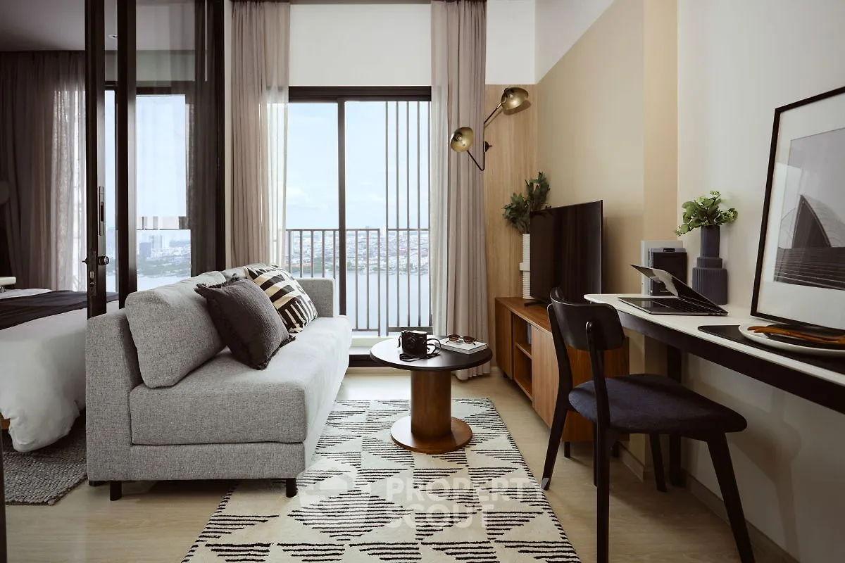 Modern living room with stylish decor and balcony view in a contemporary apartment.