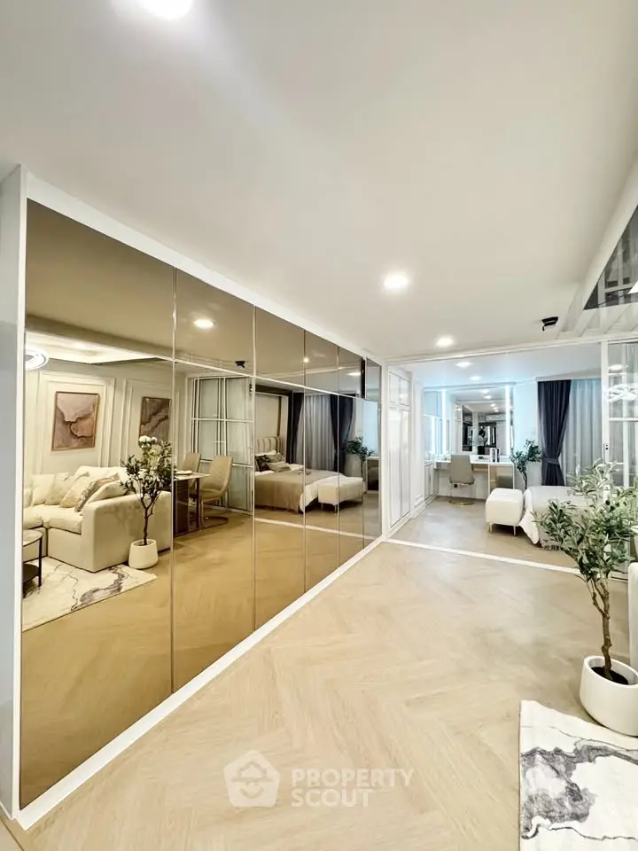 Spacious modern living room with mirrored wall and elegant decor