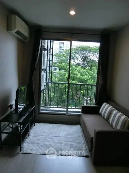 Cozy living room with balcony view and modern furnishings