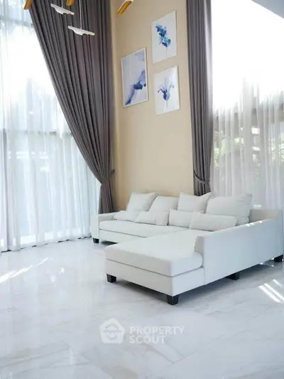 Spacious living room with high ceilings and elegant decor