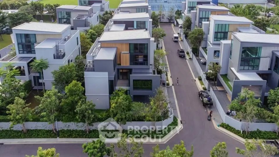 Modern luxury villas with sleek design and lush greenery in a serene neighborhood.
