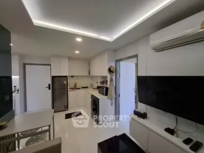 Modern kitchen with sleek appliances and open layout in a stylish apartment.