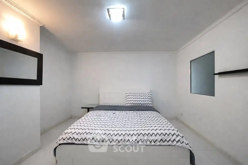 Cozy minimalist bedroom with modern decor and comfortable bedding