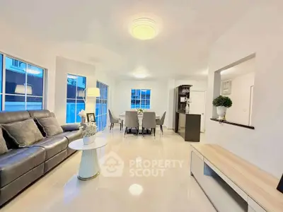 Spacious modern living room with elegant decor and ample natural light.