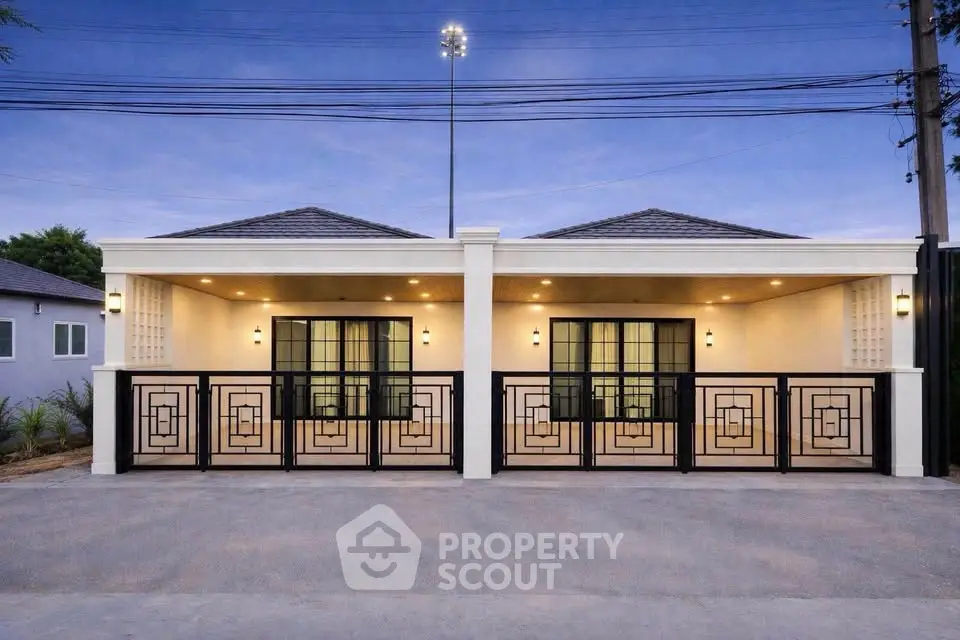 Modern duplex exterior with stylish gates and evening lighting