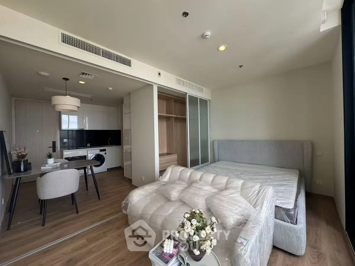 Modern studio apartment with stylish furnishings and open kitchen layout
