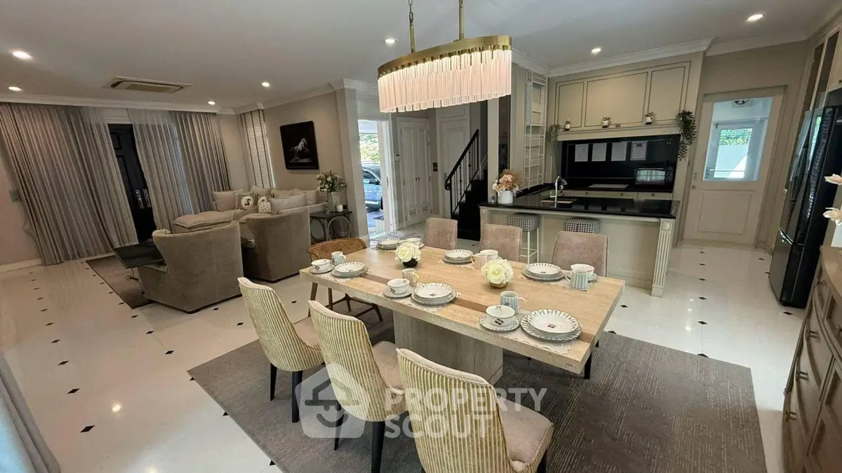 Luxurious open-plan living and dining area with elegant decor and modern kitchen.