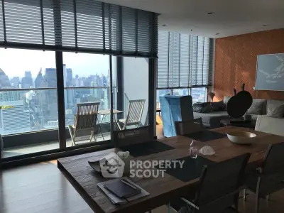 Stunning city view from modern living room with large windows and stylish decor.