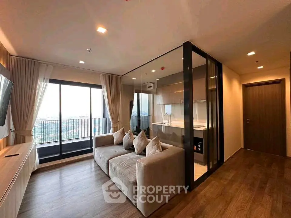 Modern living room with glass partition and balcony view in a stylish apartment.