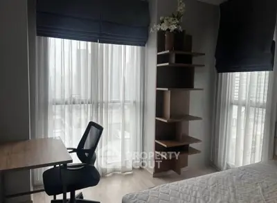 Modern bedroom with study desk and natural light in urban apartment