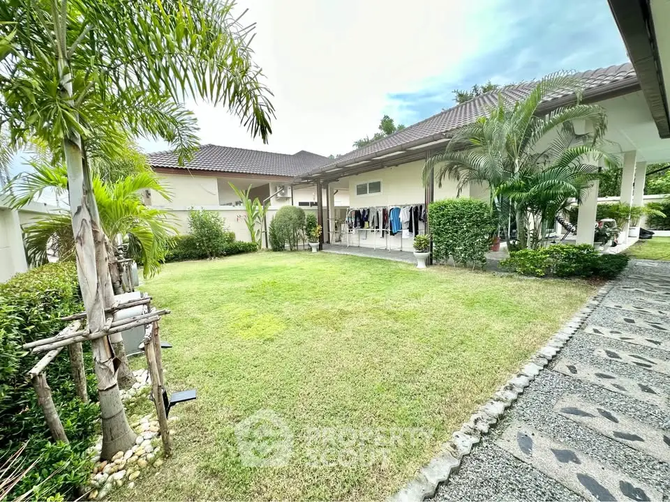 Spacious garden view with lush greenery and modern house exterior