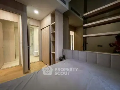 Modern bedroom with open closet and ensuite bathroom in stylish apartment