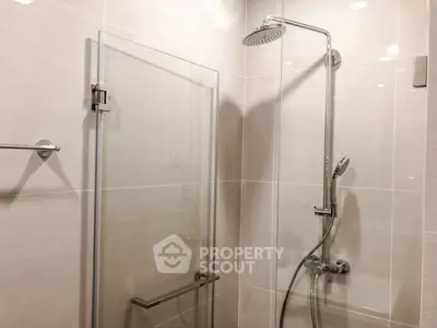 Modern bathroom with glass shower enclosure and sleek fixtures