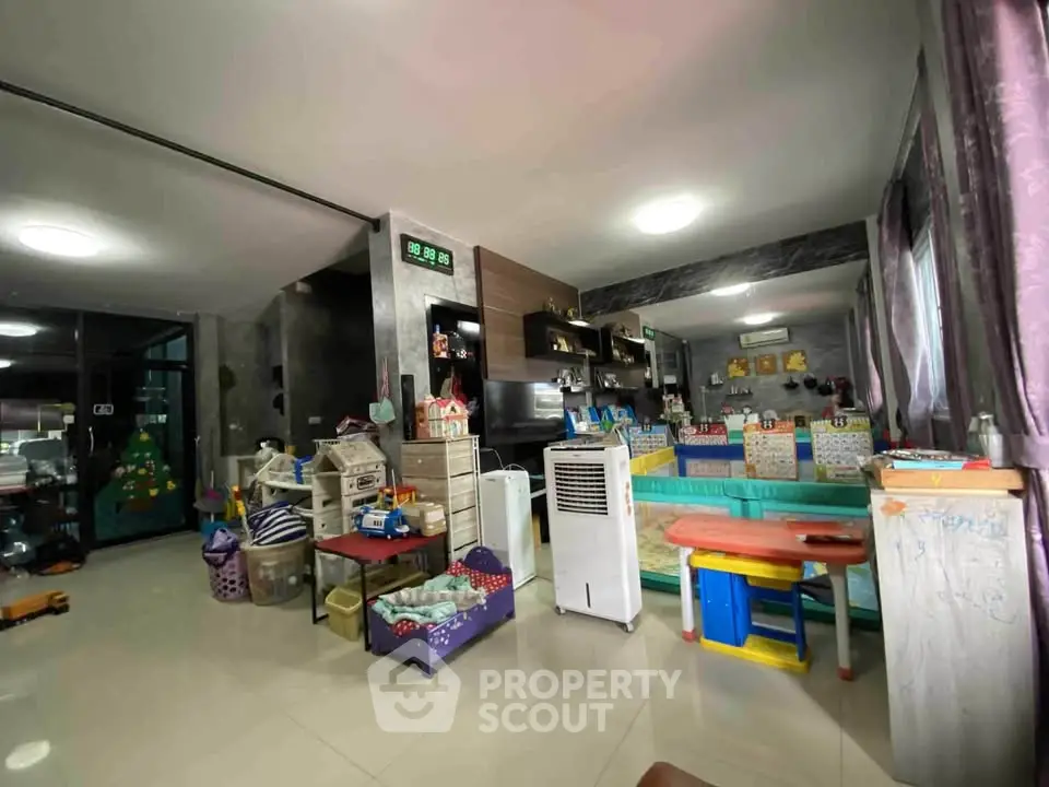 Spacious living room with modern decor and ample natural light, perfect for family gatherings.