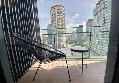 Stunning city view from modern balcony with stylish chair and table, perfect for relaxation.
