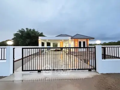 Modern single-story house with gated driveway and contemporary design