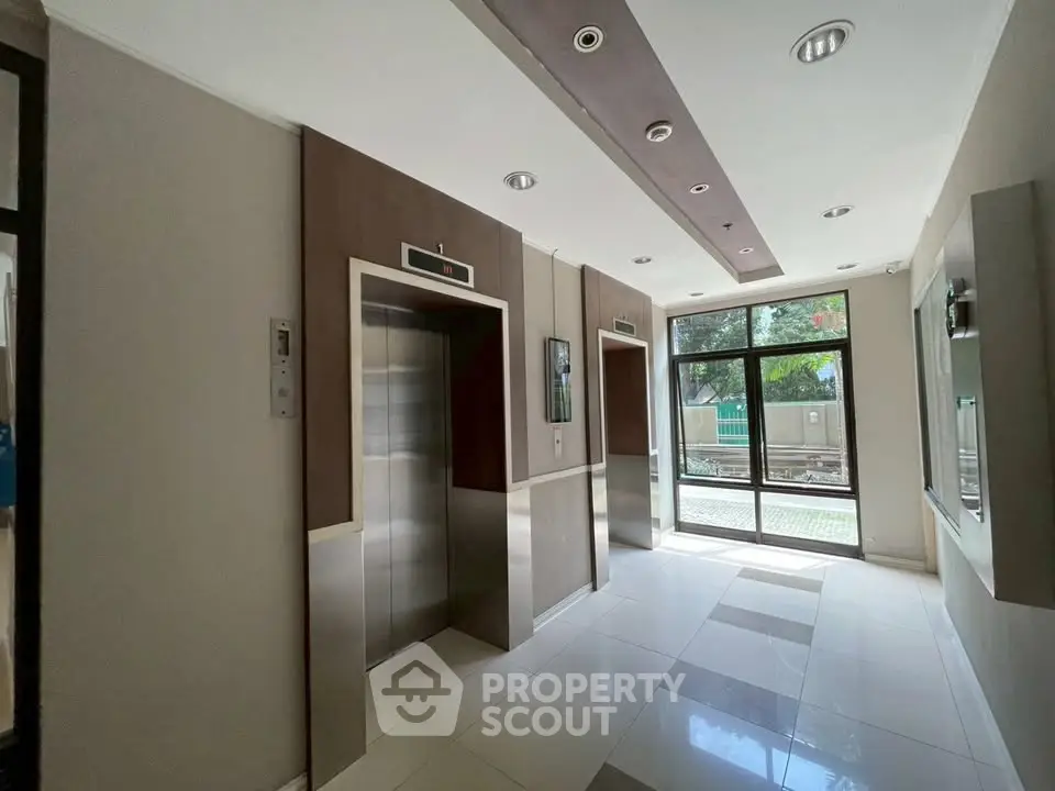 Modern building lobby with elevators and natural light