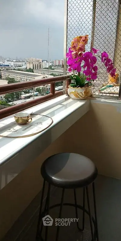 Charming balcony with city view, perfect for morning coffee and relaxation.
