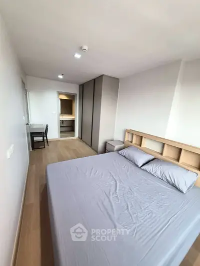 Modern minimalist bedroom with sleek furniture and ample natural light