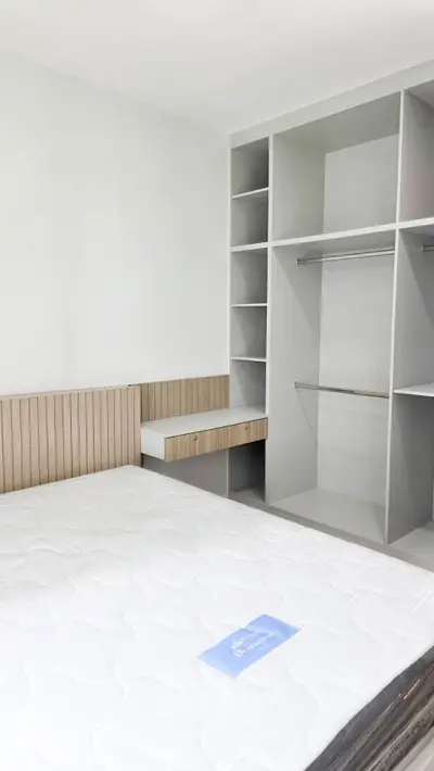 Modern bedroom with built-in closet and stylish headboard
