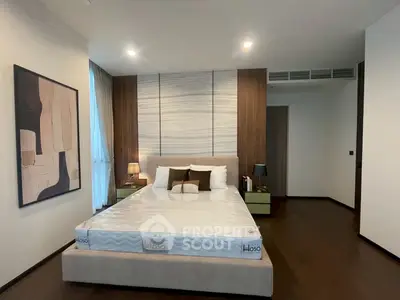 Modern bedroom with stylish decor and cozy ambiance, featuring a large bed and elegant lighting.