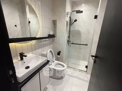 Modern bathroom with sleek fixtures and glass shower enclosure