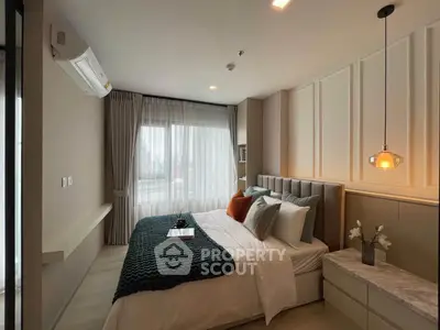 Luxurious bedroom with elegant decor and large window offering natural light
