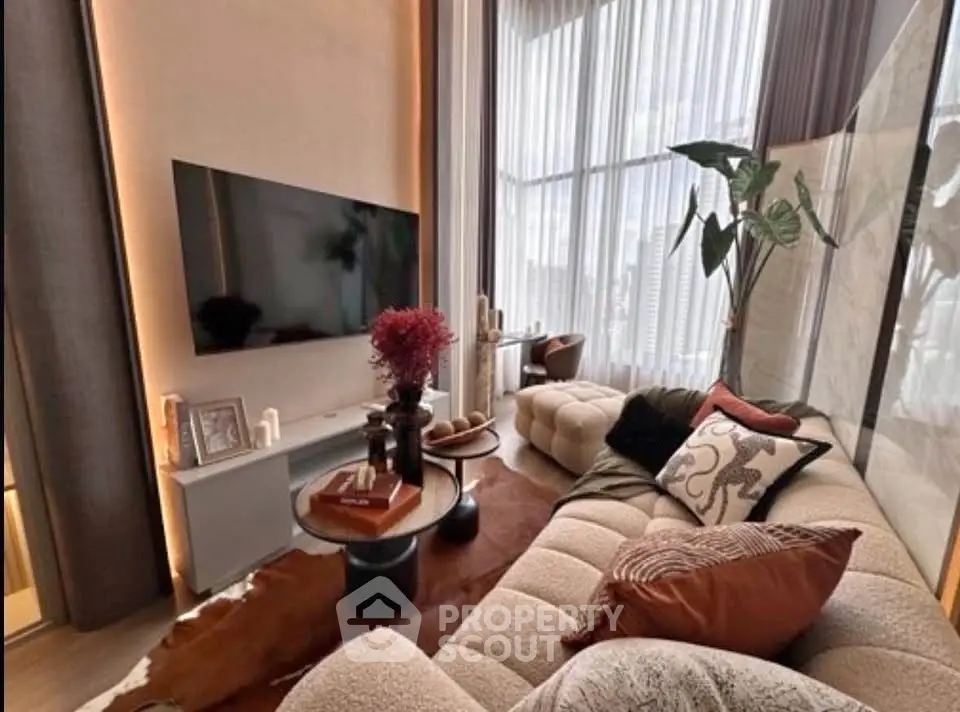 Luxurious modern living room with plush seating and large TV, perfect for relaxation and entertainment.